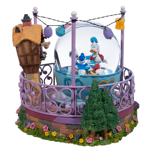 A "Donald's Mad Tea Party" Snow Globe.