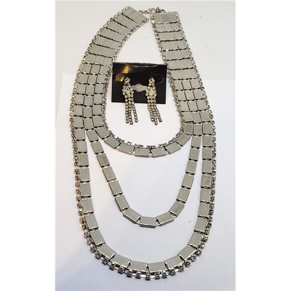 24)  STATEMENT TRIPLE STRND SILVER TONE WITH CLEAR