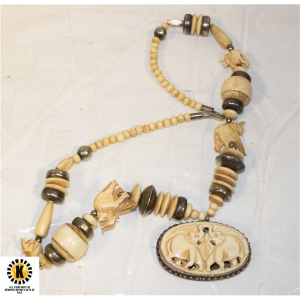 INTERESTING CARVED NATURAL MATERIAL NECKLACE