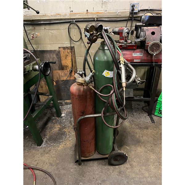 CART FOR OXY ACETYLENE TANKS WITH CUTTING TORCH, WELDING TORCH AND GAUGES. TANKS NOT INCLUDED