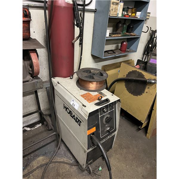 HOBART BETA-MIG 250 WIRE FEED WELDER. TANK NOT INCLUDED. SPARE ROLL OF WIRE. CART IS ON WHEELS