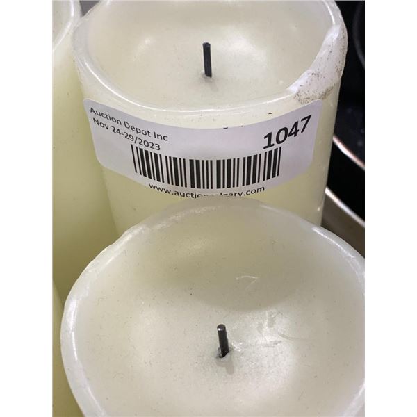 A 6 piece assorted sizes battery operated white candle set.