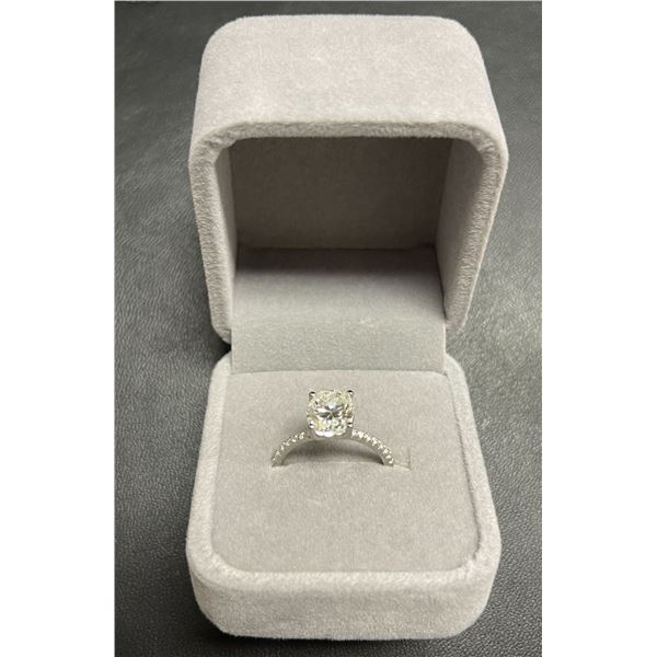 GRA certified oval cut moissanite VVS D weighing an estimated 3.00 carat w/18 round cubic zirconium