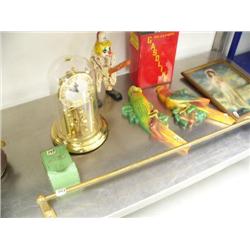 Gasoline can; matchbox; brass rail; clown; 2 pottery birds; picture of Victorian lady; gasoline can;