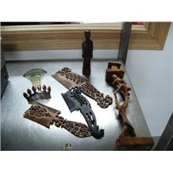 Collection of 2 carved wood figures; 3 ornately carved wooden combs; 2 old celluloid combs (25)