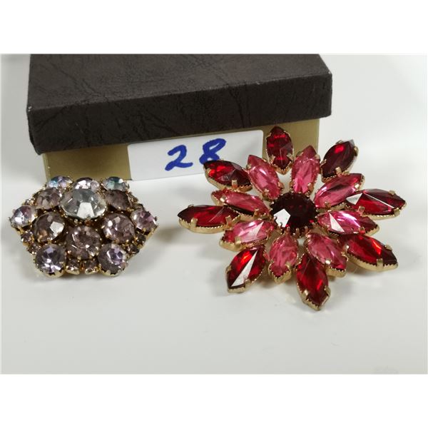 two crystal/rhinestones brooches, one from Austria