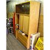 Image 1 : Wooden entertainment center with glass doors and video storage area; box of various cassette tapes; 