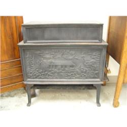 Cast iron stove with ornate castings of log cabin and trees (39)