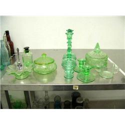 11 pieces of green depression glass: 3 sets of candle sticks; 2 covered dishes with 1 with chip on l