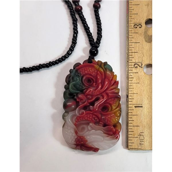 18)  MULTI COLORED JADEITE DRAGON PENDANT ON A