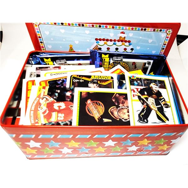 34)  FESTIVE TIN CONTAINING 100'S OF ASSORTED HOCK