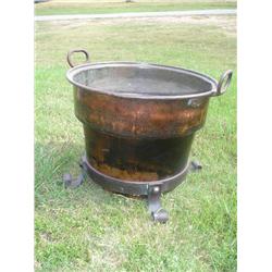 Large copper pot on stand