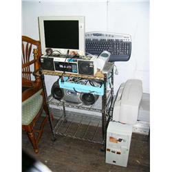 Philips radio and CD player; Panasonic boom box; computer with Microsoft keyboard, flat screen monit