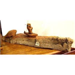 Cottonwood bark carving of hunter and seal 21" long (2)