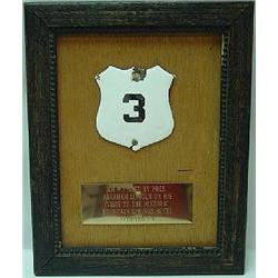 FRAMED WHITE ENAMELED METAL SHIELD