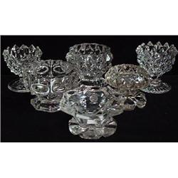 A PAIR OF CLEAR PRESSED GLASS FOOTED SALTS