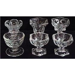 SIX ODD CLEAR PRESSED GLASS FOOTED OPEN SALT DIPS