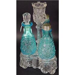 A CLEAR PATTERN PRESSED GLASS 3 BOTTLE CASTOR STAND