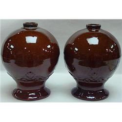 A PAIR OF BROWN GLAZED STONEWARE NEWELL POSTS