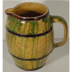 A STONEWARE BARREL SHAPED PITCHER