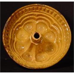 A PENNSYLVANIA REDWARE "TURK'S HEAD" PUDDING OR CAKE MOLD