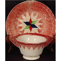 RED SPATTERWARE HANDLE-LESS TEA CUP AND SAUCER