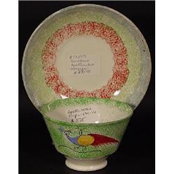 "PEACOCK" GREEN SPATTERWARE HANDLE-LESS TEA CUP TOGETHER WITH RAINBOW SPATTERWARE SAUCER