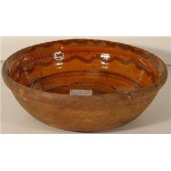 A PENNSYLVANIA REDWARE LARGE ROUND DEEP SIDED BOWL