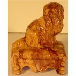 YELLOW OCHREWARE POTTERY SCULPTED SEATED SPANIEL