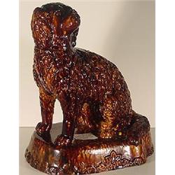 YELLOW OCHERWARE / ROCKINGHAM TORTOISE-SHELL GLAZED SCULPTED SEATED SPANIEL