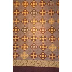 A HAND SEWN PATCHWORK QUILT