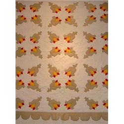 A HAND SEWN APPLIQUÉD QUILT