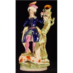 STAFFORDSHIRE PORCELAIN FIGURE OF A FALCONER AND HIS DOG