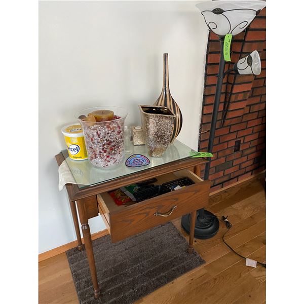 Small table c/w décor, contents in draw, rug, and upright floor lamp
