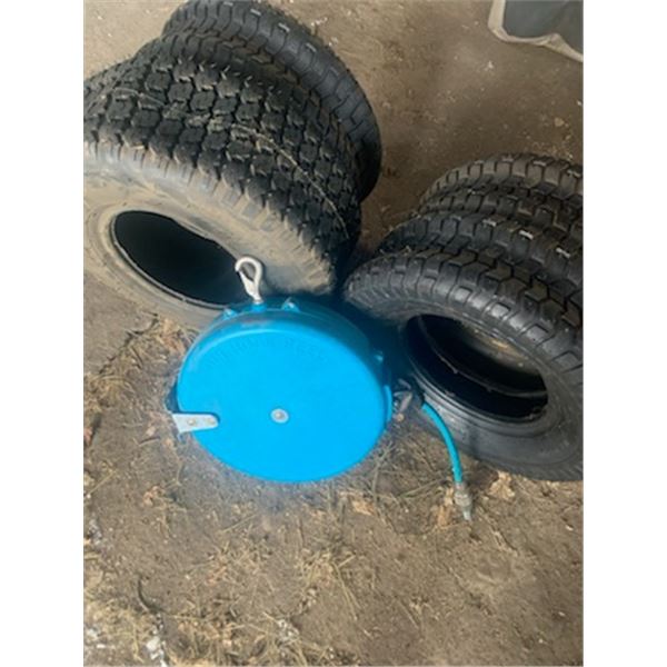 4- Various lawn tractor tires, a few are 16x6.50 -8 and a blue hose reel.