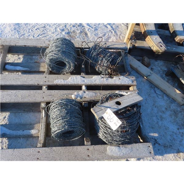 four partial rolls of barbed wire one may be full