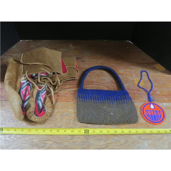 pair of mukluks, beaded purse and beaded Oilers decoration