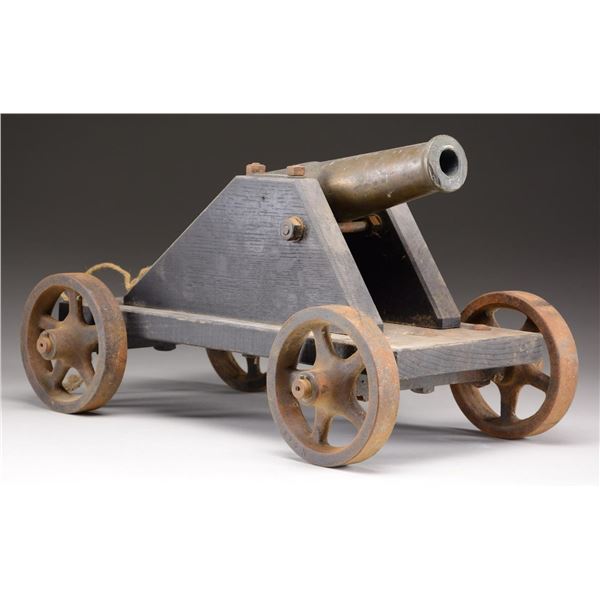 A BRASS SIGNAL CANNON ON CARRIAGE.