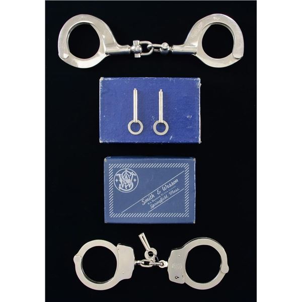 2 PAIRS OF HANDCUFFS BY S&W AND H&R.