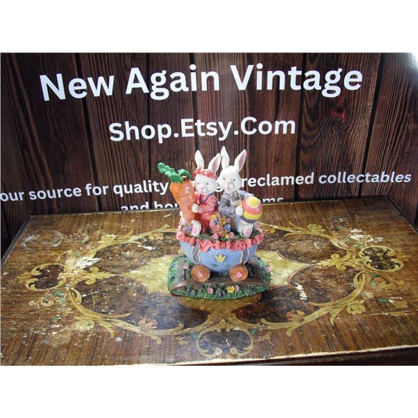 TWO RABBITS IN EGG CART