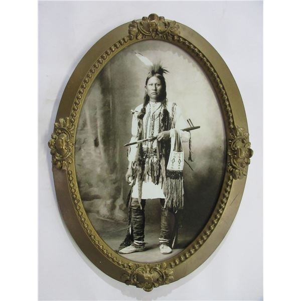Unmarked Oval Photo Of Indian Holding A Tobacco Pipe- 23" X 17"