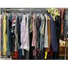 Image 1 : Rack full of assorted movie set dec clothing - includes tank tops / jackets / pants / shirts etc - a