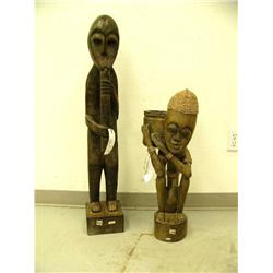 Lot of 2 African stylized wooden figures- with flute 39-1/2" tall, with basket 27" tall (1)