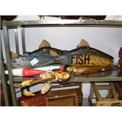 Lot of fish related items- 3 large carved fish; wooden lures oversized; poles with fish (1)