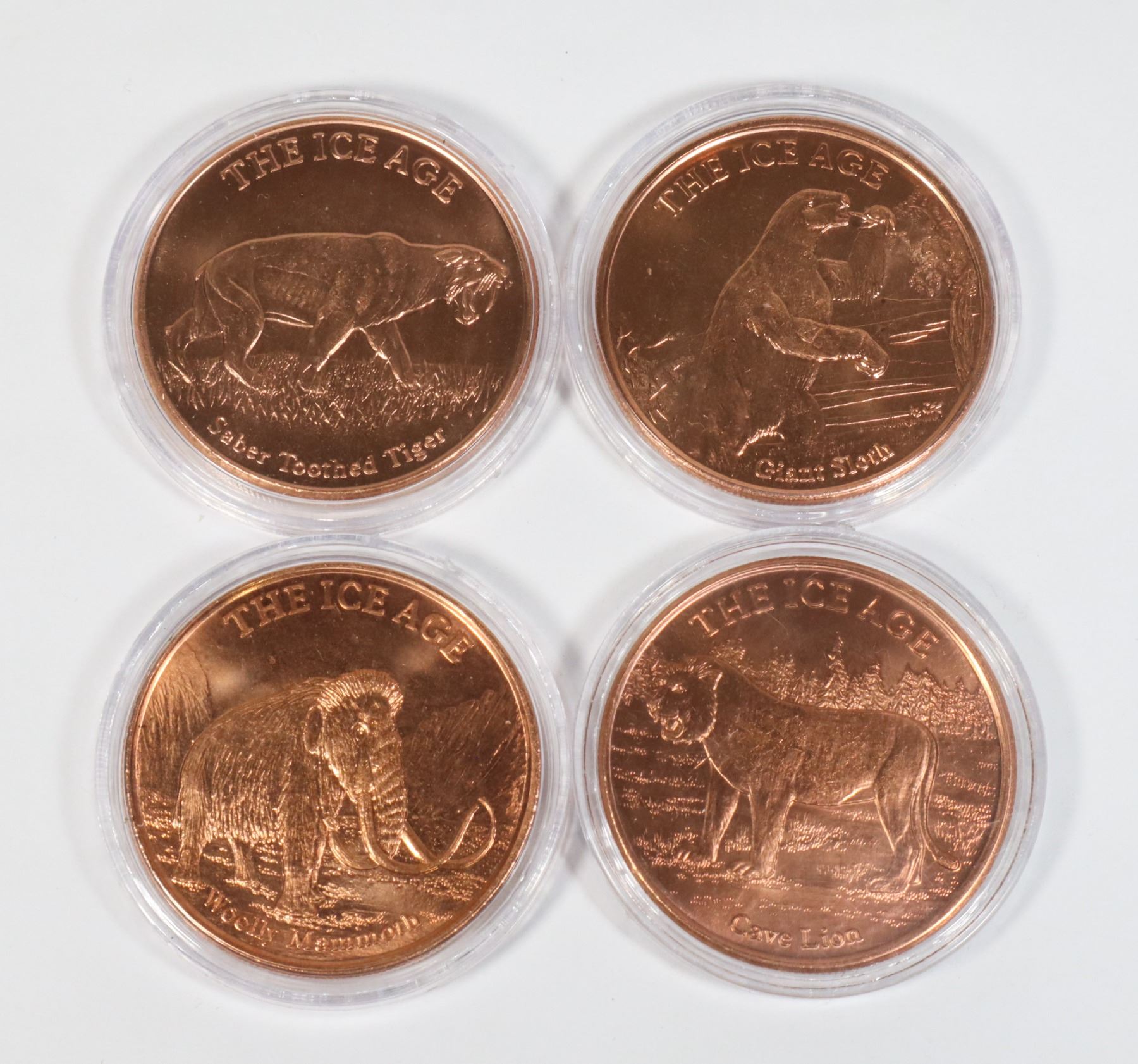 FOUR 1-OZ ICE AGE THEMED COPPER ROUNDS IN CAPSULES