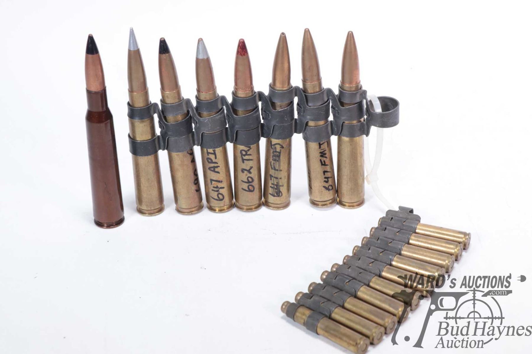 Eight live .50 cal rounds attached to section of linked belt plus ten ...