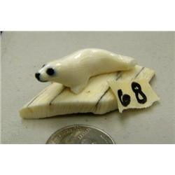 Little ivory seal on ivory base by Thomas Pushruk from King Island, 2005, indicated he is 79 years o