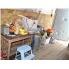 Image 1 : Small table; trash can; tool boxes; extension cords; tools; nails; saws; blue plastic step stool (81