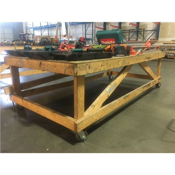 LARGE WOODEN ROLLING WORK TABLE - APPROX. 4FT X 8FT X 2 1/2FT HIGH
