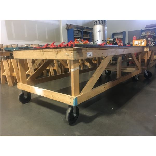 LARGE WOODEN ROLLING WORK TABLE - APPROX. 4FT X 8FT X 2 1/2FT HIGH
